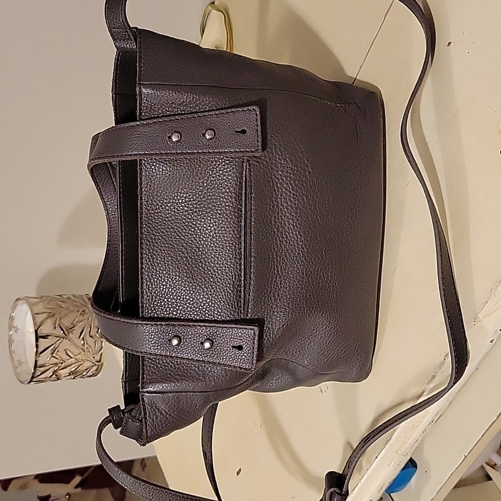 The Sak women's  grey leather purse. Shoulder strap and short handles.